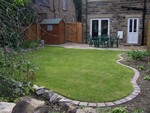 Rear garden with patio and outside storage